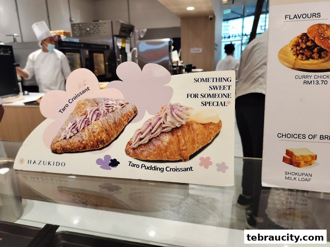 A display of delicious croissants and bread at a bakery cafe.