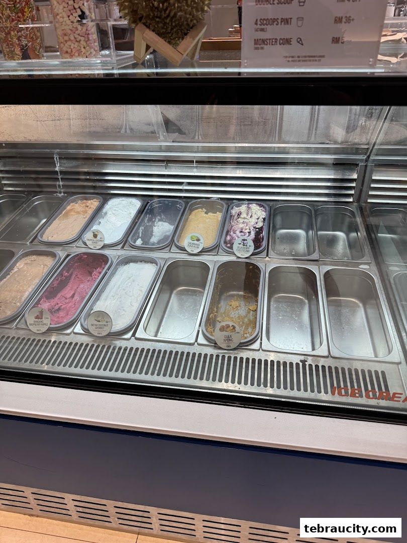 A display case filled with various flavors of ice cream and empty containers.
