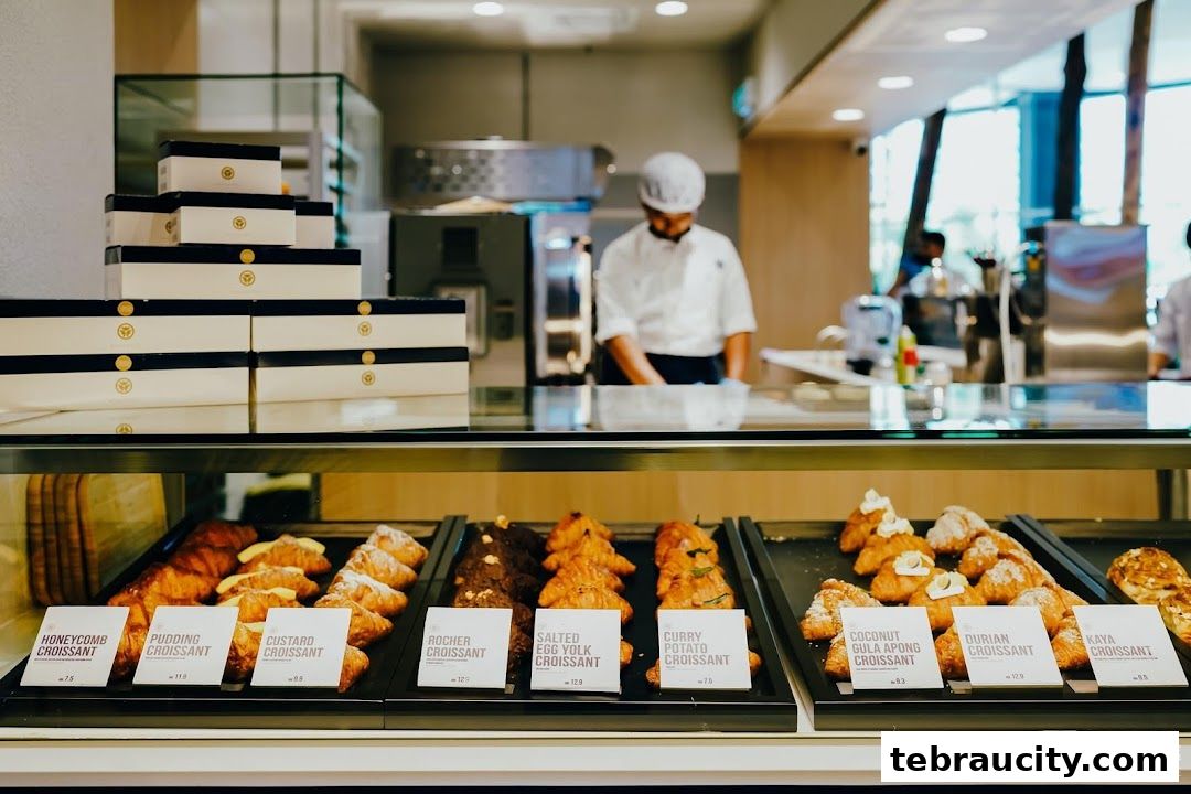 A display case filled with various croissants at Hazu Bakery Cafe.