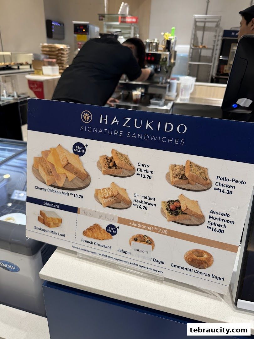 A menu board displaying signature sandwiches and bread choices at Hazu Bakery Cafe.