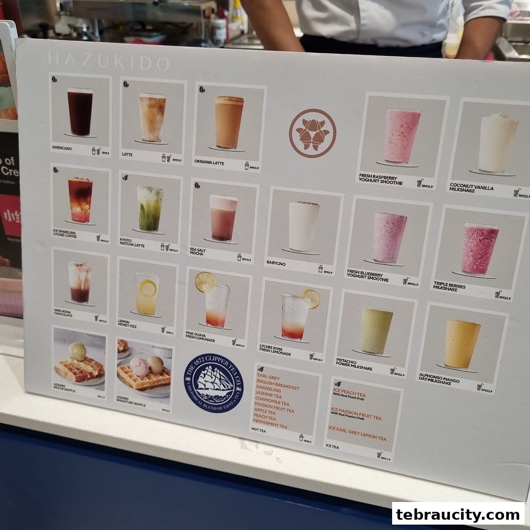 A menu board displaying various drinks and waffles from Hazukido Bakery Cafe.