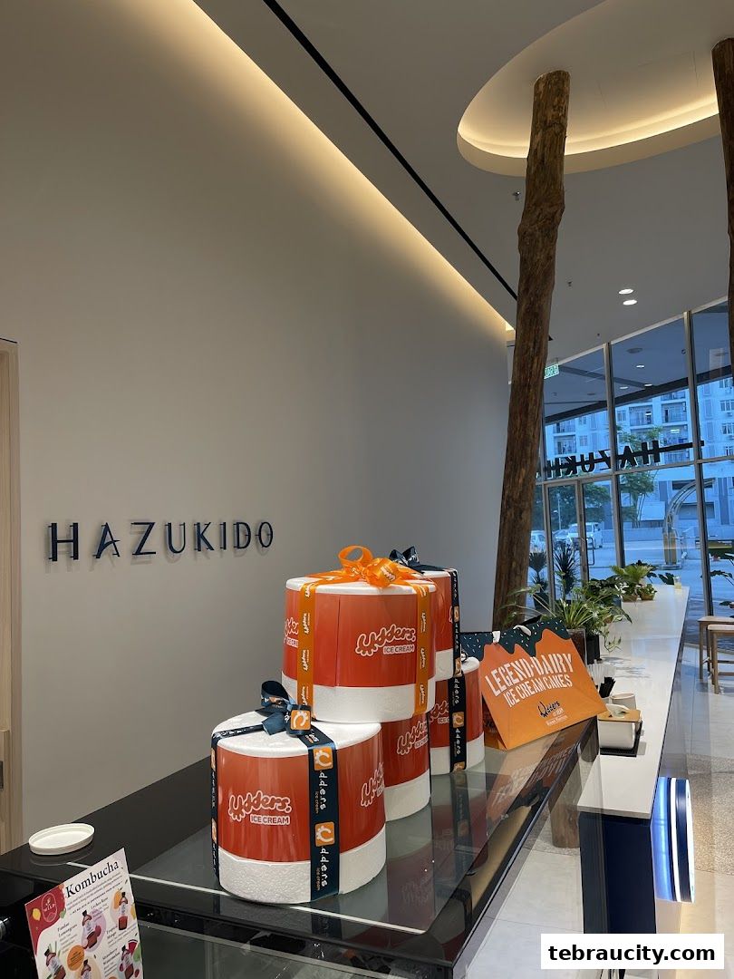 Interior view of Hazu Bakery Cafe with ice cream cakes and branding.