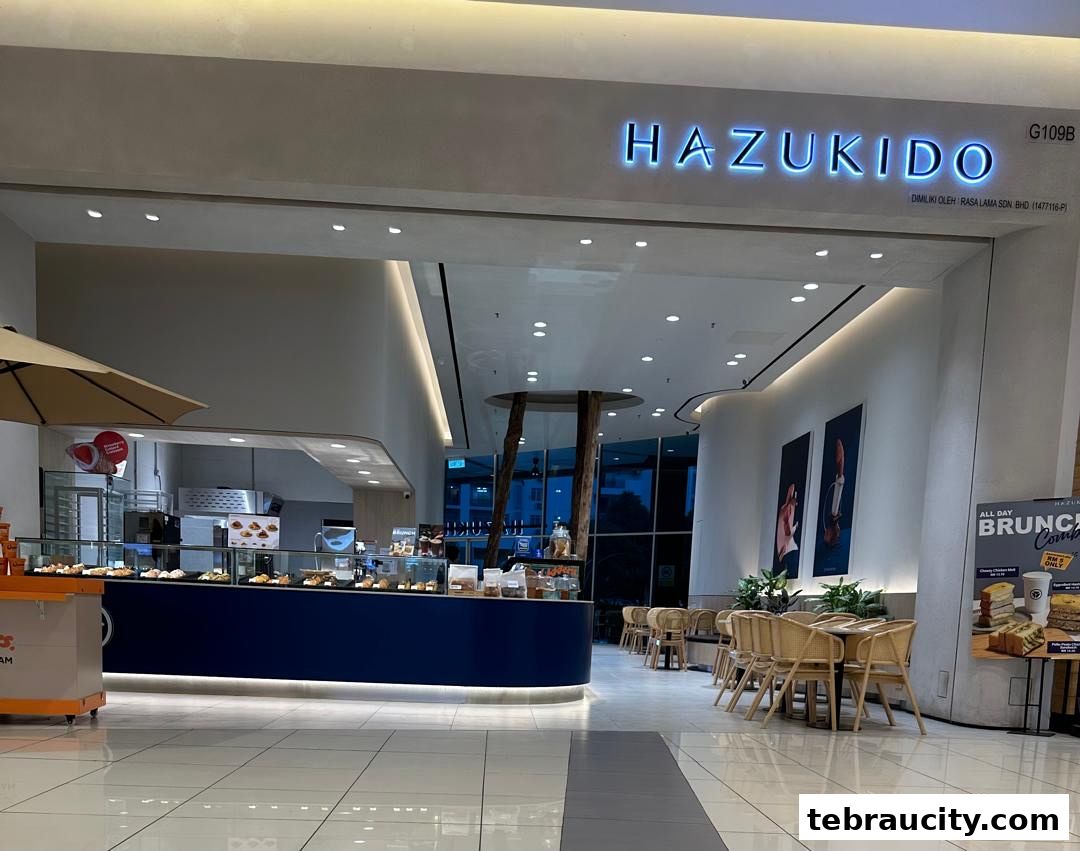 The exterior of Hazu Bakery Cafe with a display of pastries and seating area.