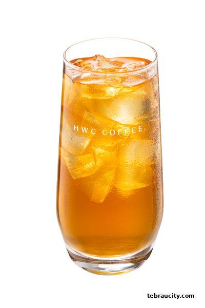 A tall glass filled with iced tea and ice cubes, featuring the HWC Coffee logo.