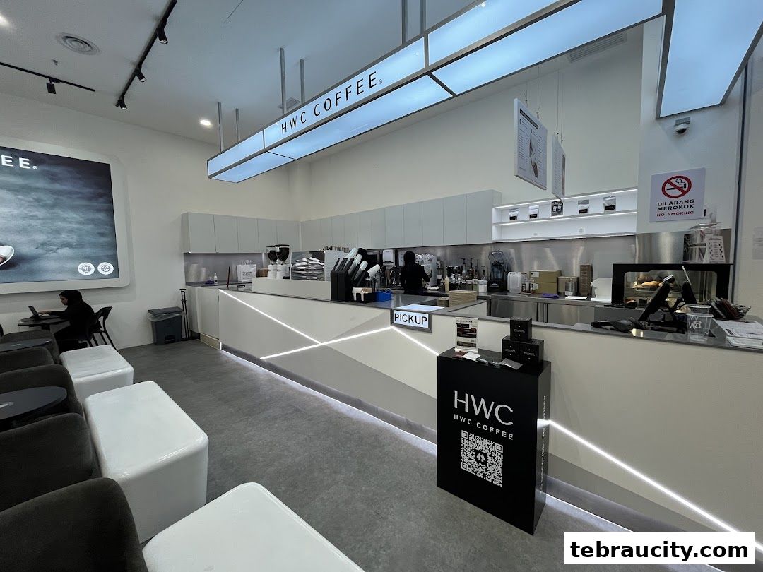 Interior view of a modern HWC Coffee shop with a long counter and seating area.