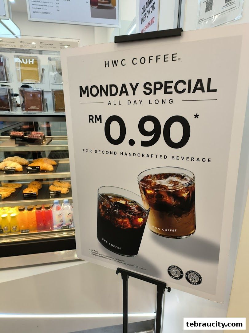 A sign advertising HWC Coffee's Monday Special for a second handcrafted beverage at RM 0.90.