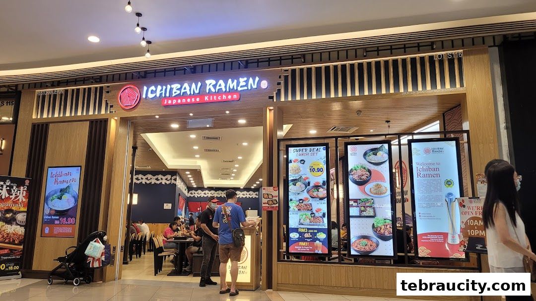 The exterior of Ichiban Ramen, a Japanese kitchen, with customers dining inside and promotional displays.
