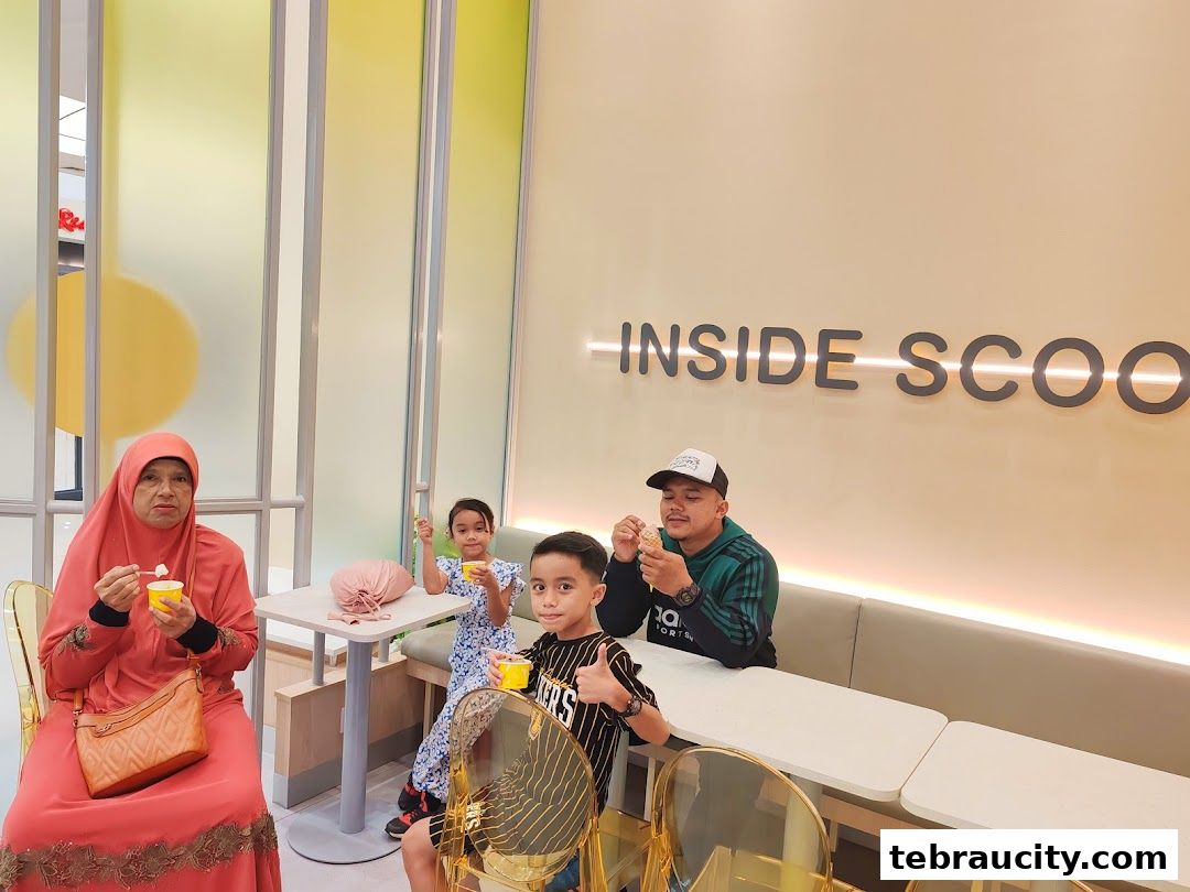 A family enjoys ice cream at Inside Scoop, with the shop's logo visible on the wall.