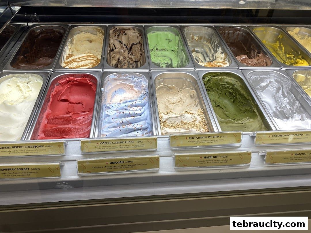 A display of various flavors of ice cream in metal containers with labels.
