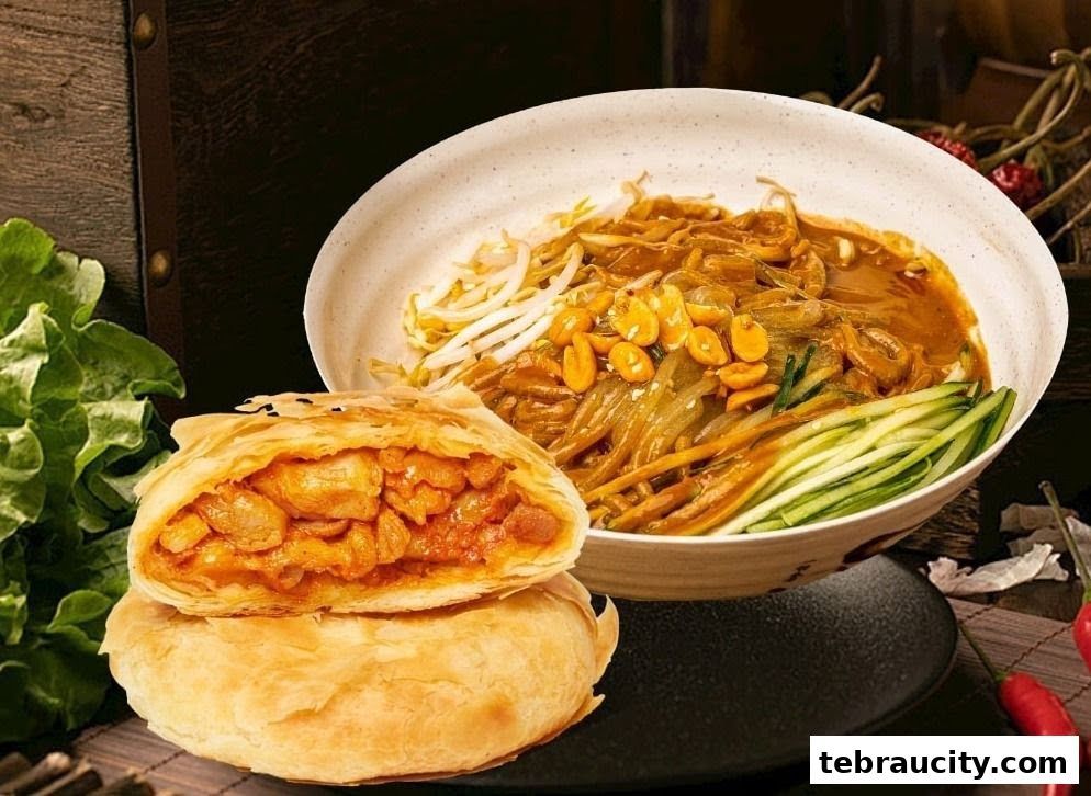 A delicious-looking pastry filled with meat next to a bowl of noodles with peanuts and cucumber.