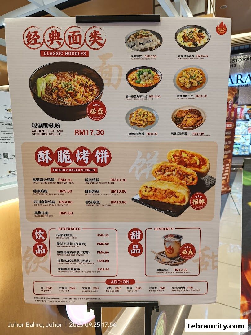 A menu board displays classic noodles, freshly baked scones, beverages, and desserts with prices.
