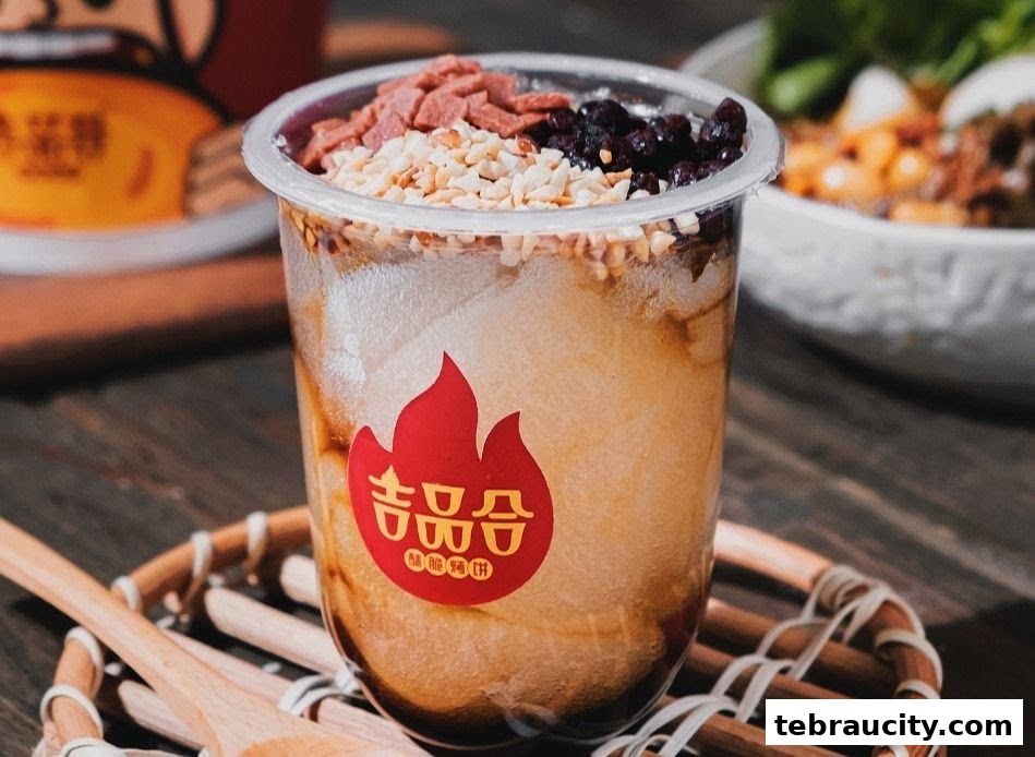 A close-up of a refreshing dessert drink with toppings of nuts and dried fruit.