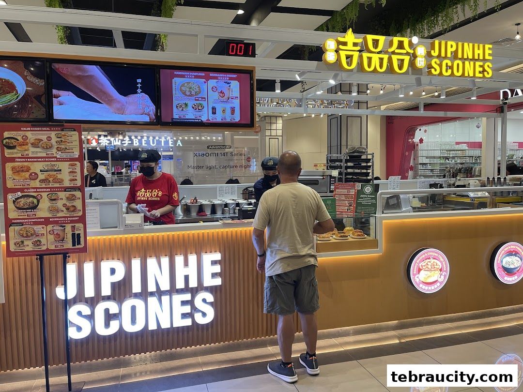 A customer stands at the counter of Jipinhe Scones, a food stall in a shopping mall.