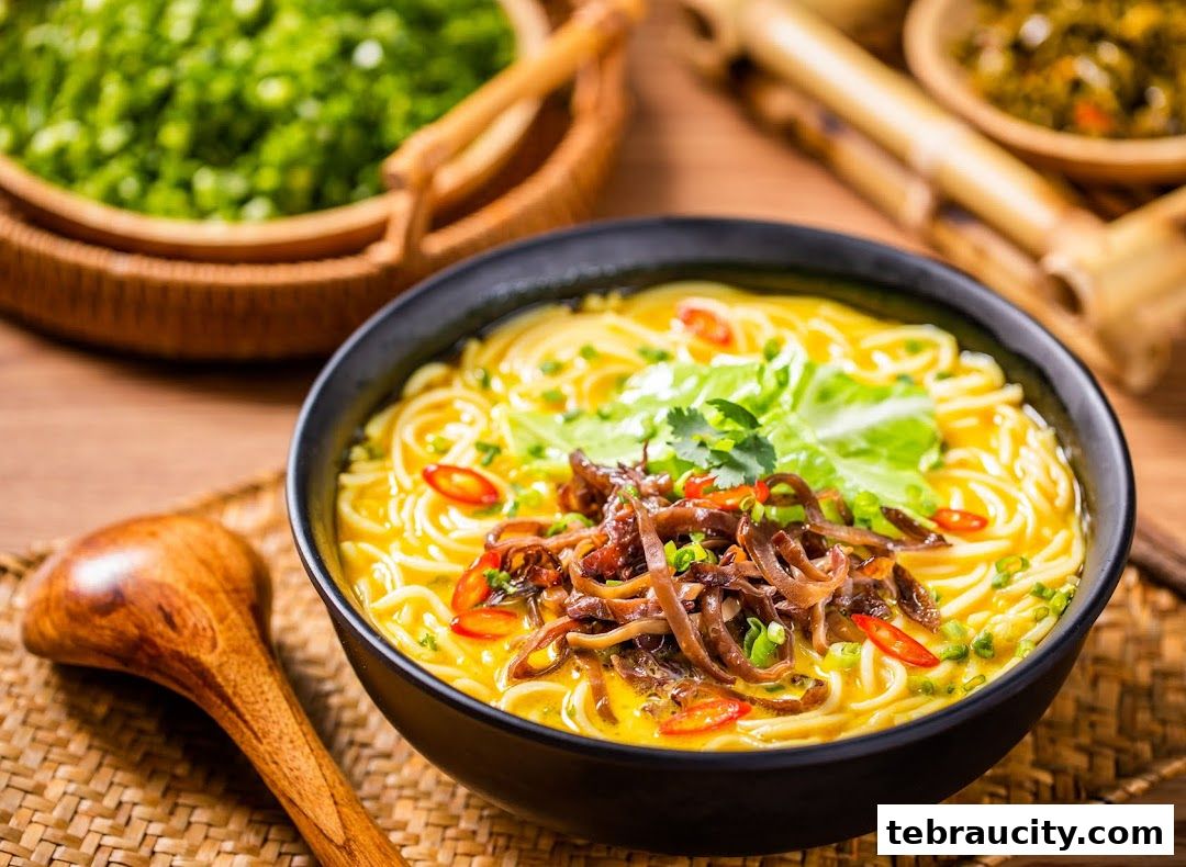 A steaming bowl of noodle soup with fresh toppings and a wooden spoon.