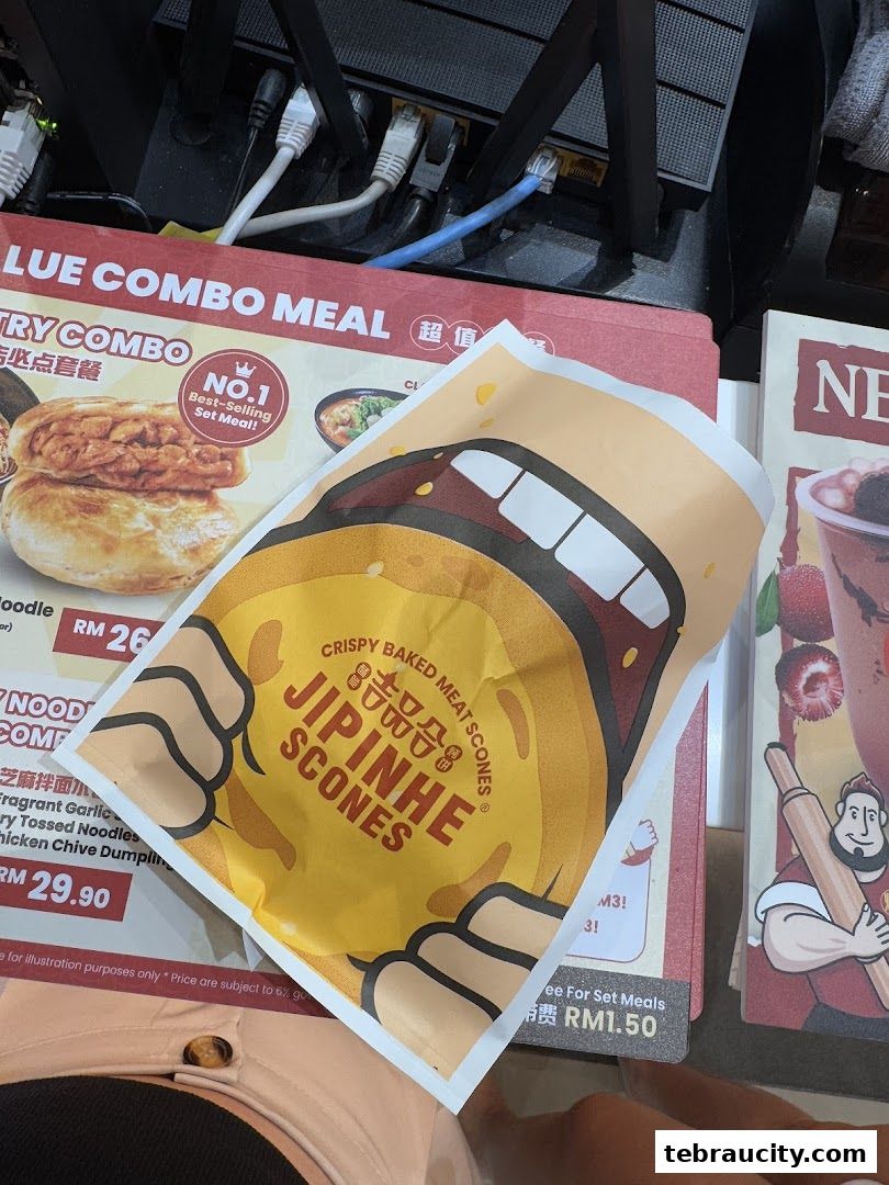 A close-up of a Jipinhe Scones promotional flyer with menu items in the background.