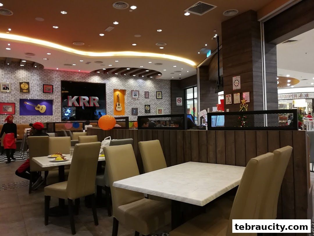 Interior view of Kenny Rogers Roasters restaurant with tables and chairs.