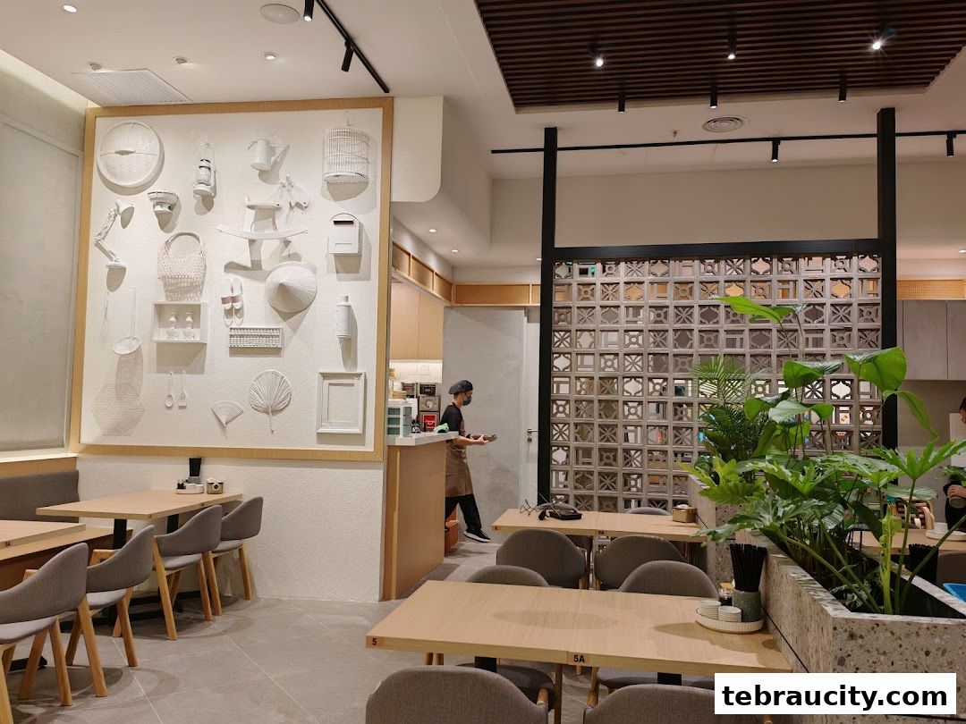Interior of a modern restaurant with tables, chairs, and decorative wall art.