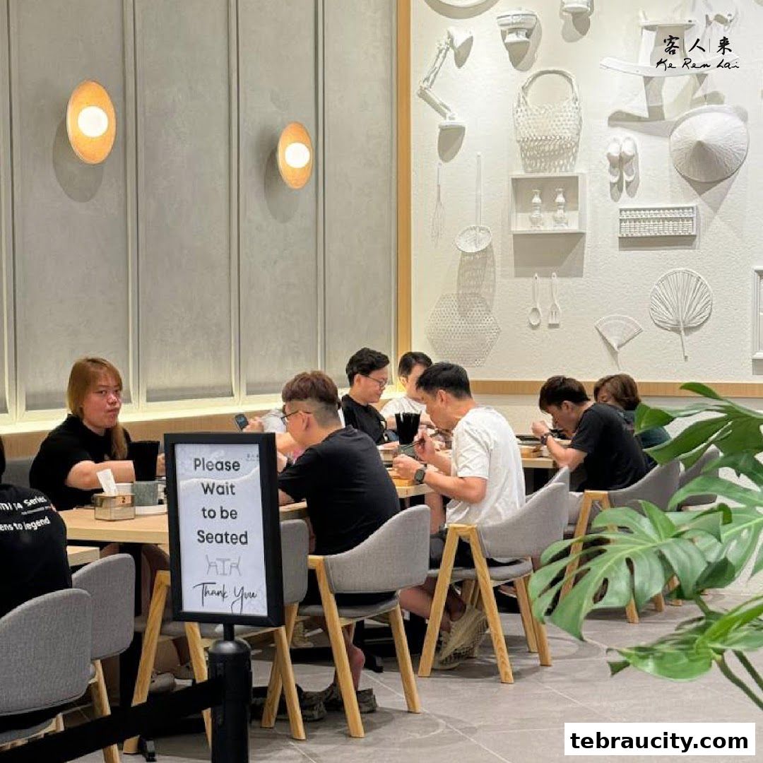 Diners are seated at tables in a modern restaurant with decorative wall art.