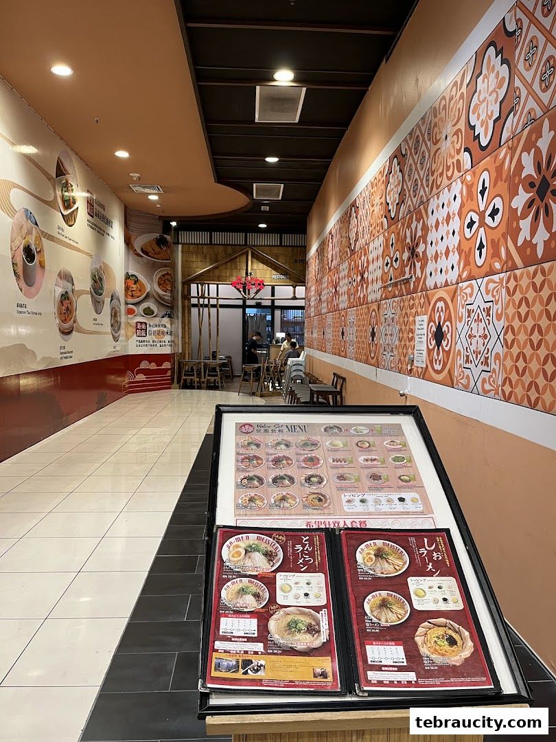 A menu stand displaying various ramen dishes and set menus outside a restaurant.