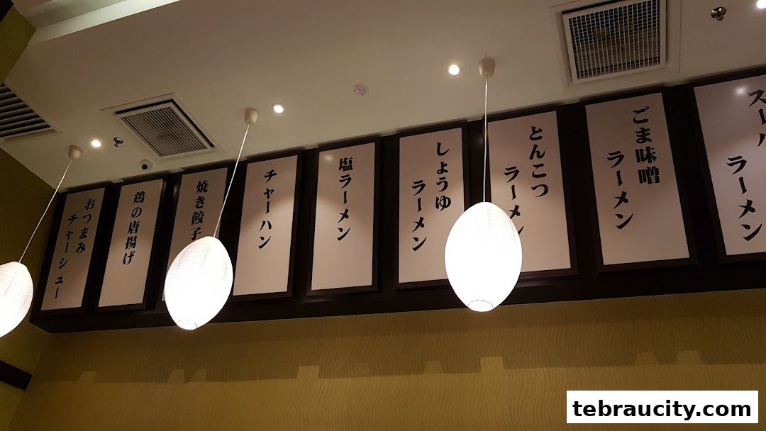 A row of Japanese menu items displayed on white boards with Japanese text.