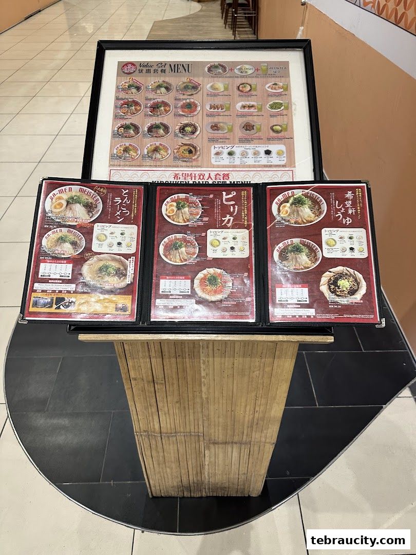 A display of ramen menus on a wooden stand.