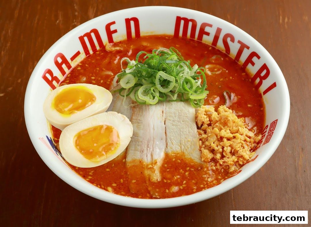 A bowl of ramen with pork, egg, and green onions in a rich broth.