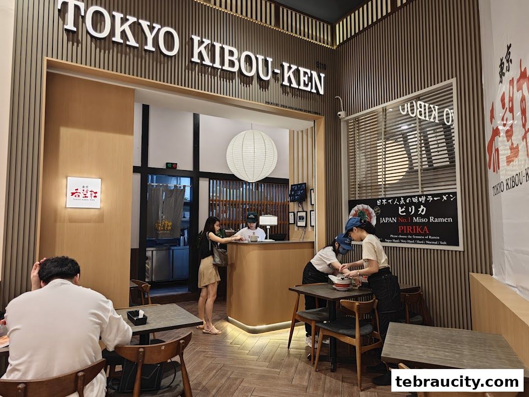 Interior view of Tokyo Kibou-Ken ramen shop with customers and staff.