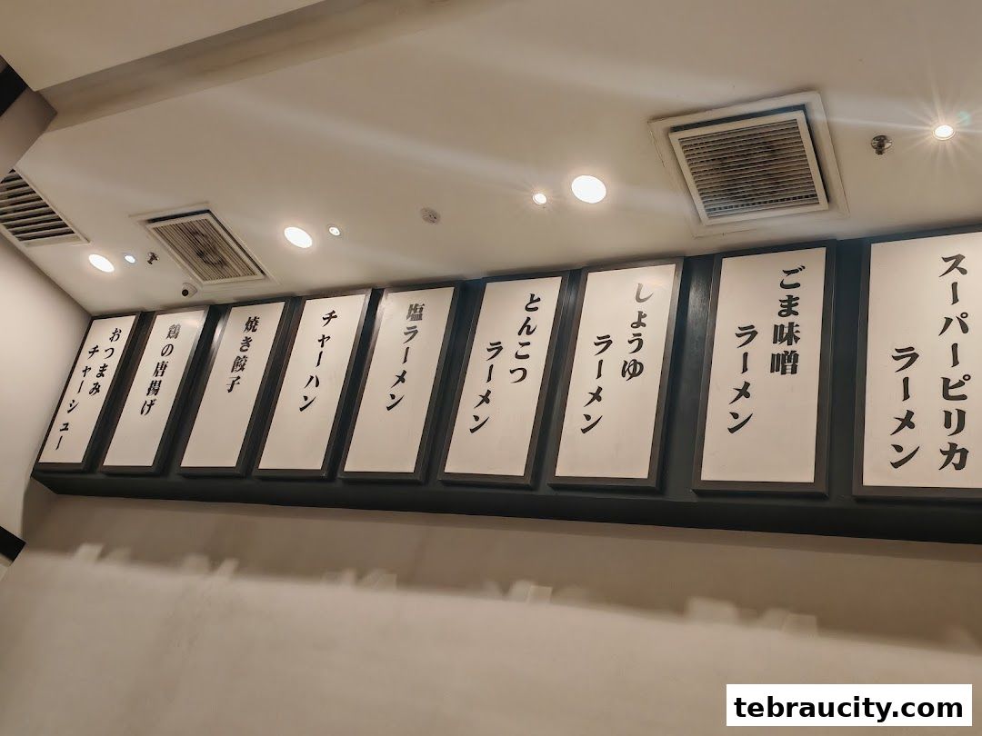 A menu board displaying various ramen dishes and other Japanese food items.