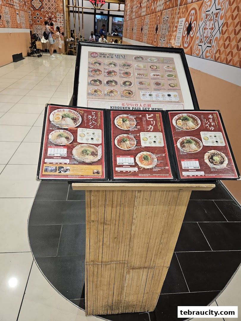 A display stand with menus for Kibou-ken, showcasing ramen dishes and set meals.