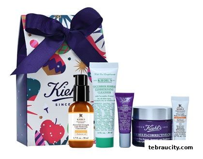 A Kiehl's gift set featuring various skincare products and a branded gift bag.