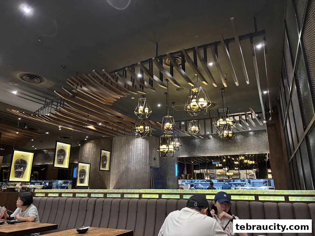 Interior of a Japanese restaurant with modern decor, featuring unique lighting and artwork.