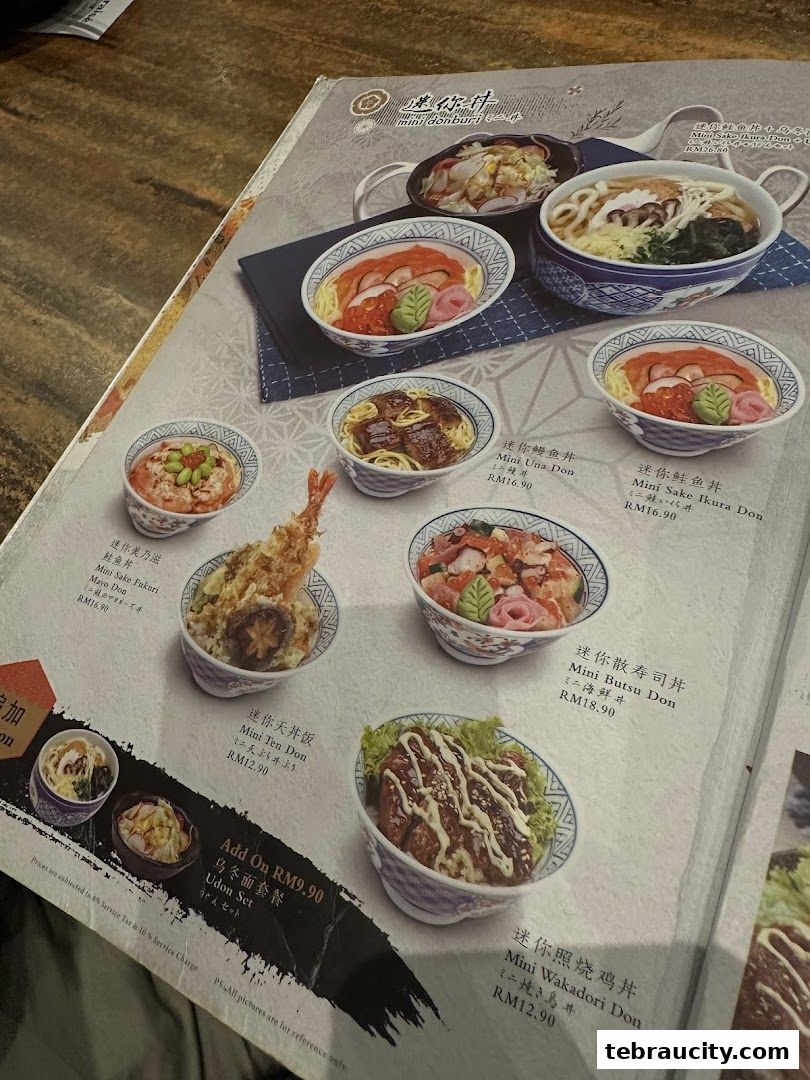 A menu page from Kinsahi Japanese Restaurant showcasing various donburi dishes and udon sets.