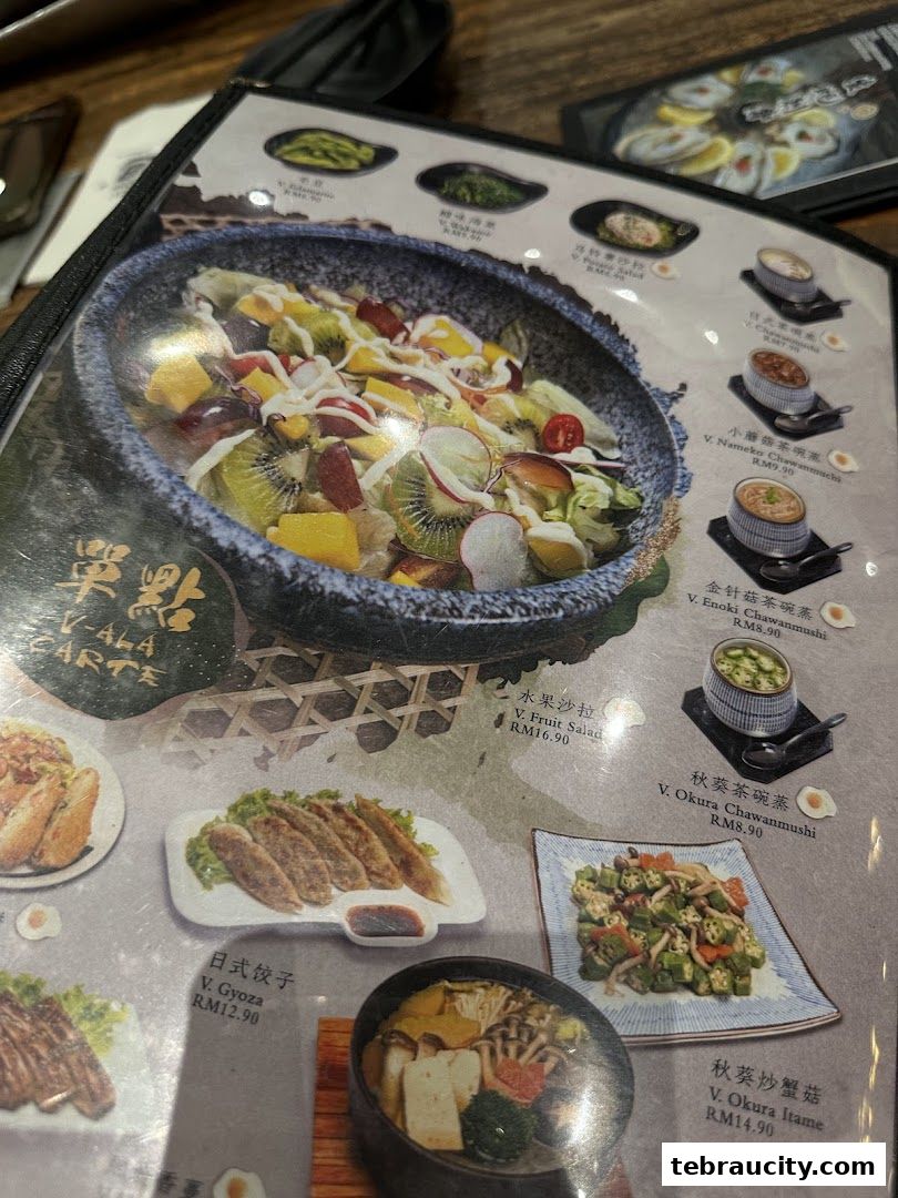A close-up of a Japanese restaurant menu featuring various dishes with images and prices.
