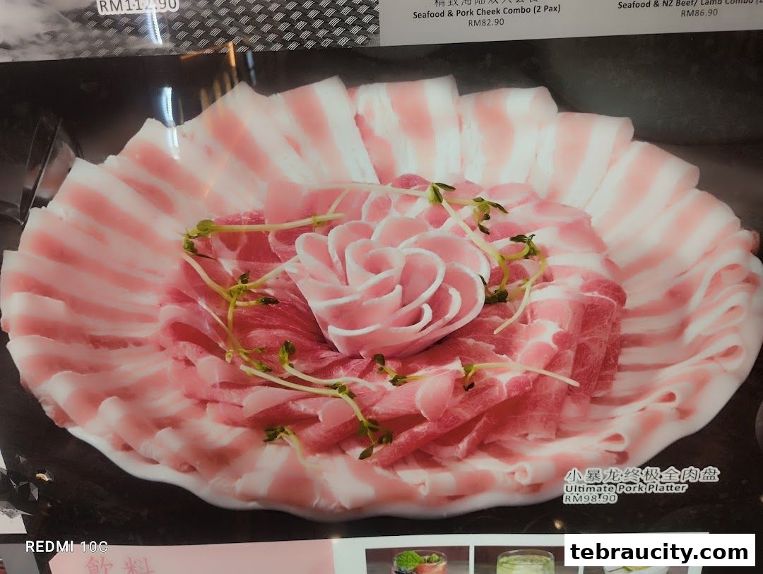 A close-up of a beautifully arranged pork platter with thinly sliced meat.