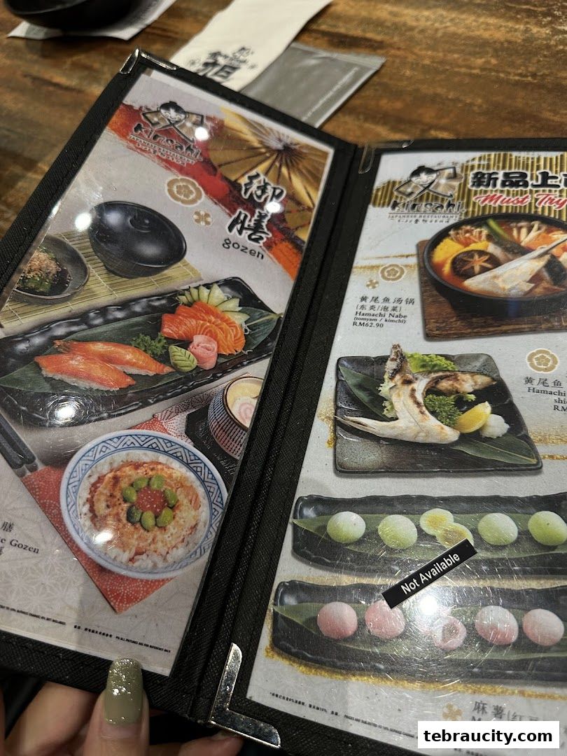 A close-up of a Japanese restaurant menu featuring various dishes and prices.
