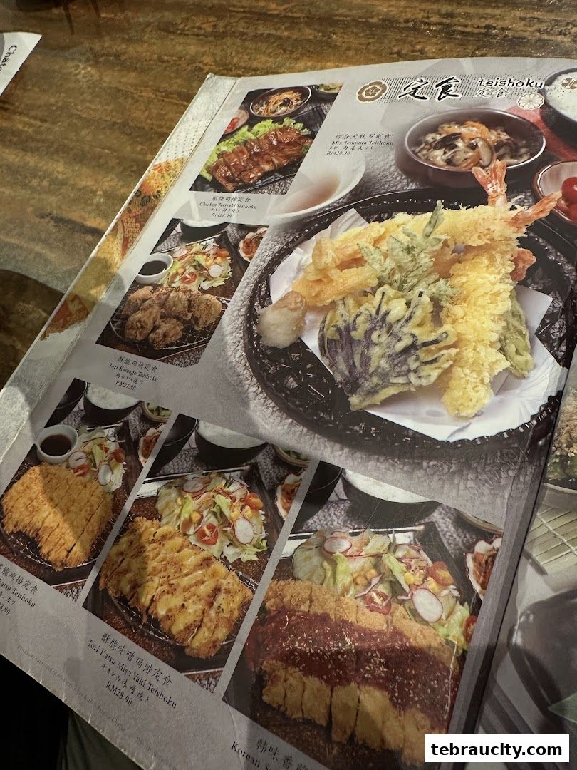 A menu from Kinsahi Japanese Restaurant featuring various teishoku meals with appetizing food photography.