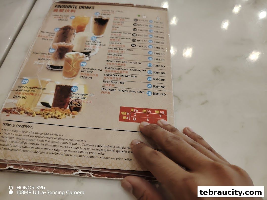 A menu from Kuu By Tea Garden featuring various drinks with images and prices.