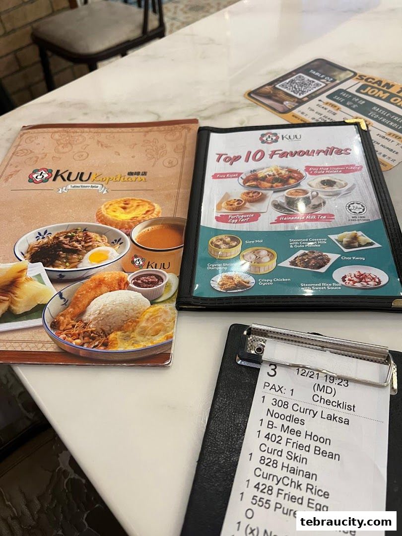 A menu from Kuu Kopitiam featuring top 10 favorites and a customer's order receipt.