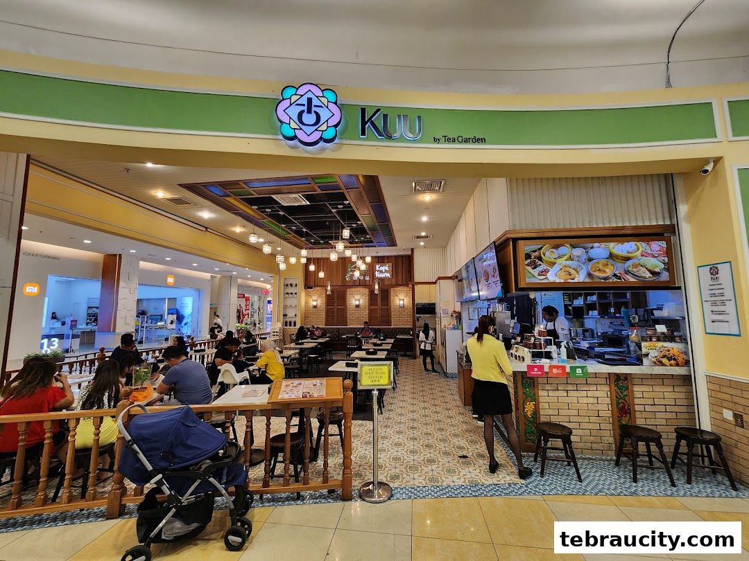 Interior view of Kuu by Tea Garden restaurant with customers dining and staff serving.
