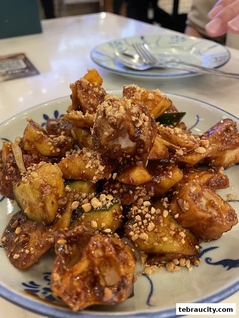 A close-up of a plate of Rojak, a traditional Malaysian fruit and vegetable salad.