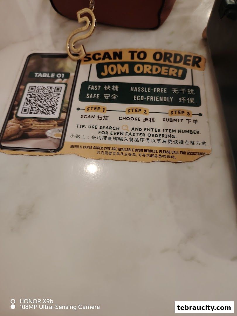 A table marker with a QR code for ordering at Kuu By Tea Garden.
