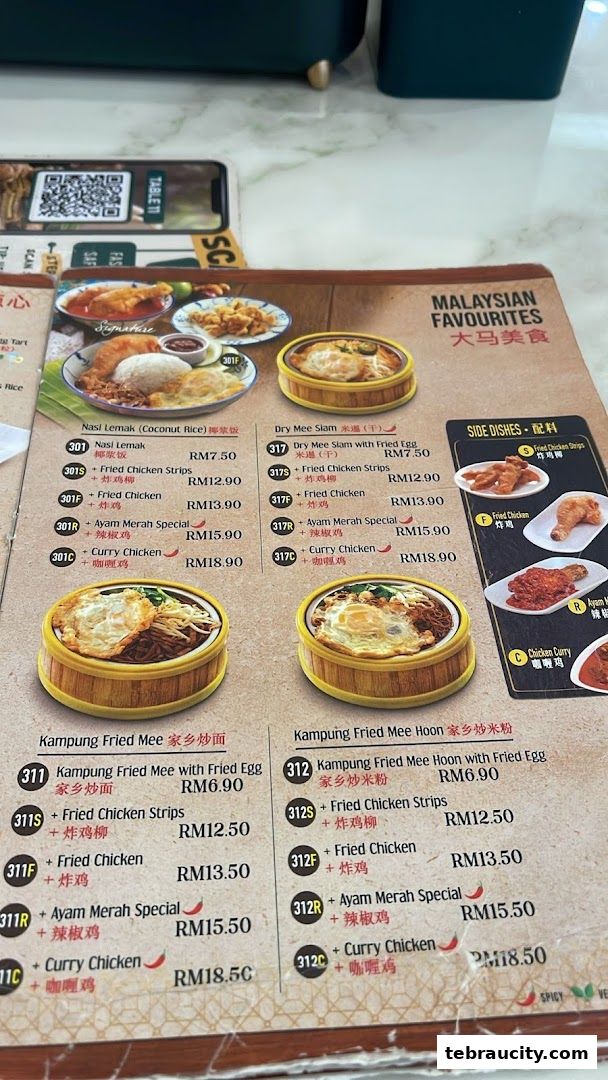 A menu from Kuu By Tea Garden featuring Malaysian favorites like Nasi Lemak and Fried Mee Hoon.