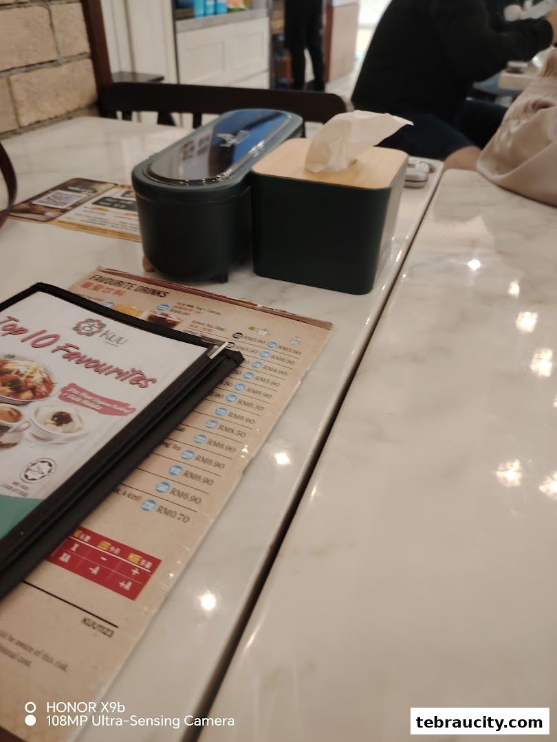 A menu from Kuu By Tea Garden Aeon Tebrau City showing favorite drinks and top 10 favorites.