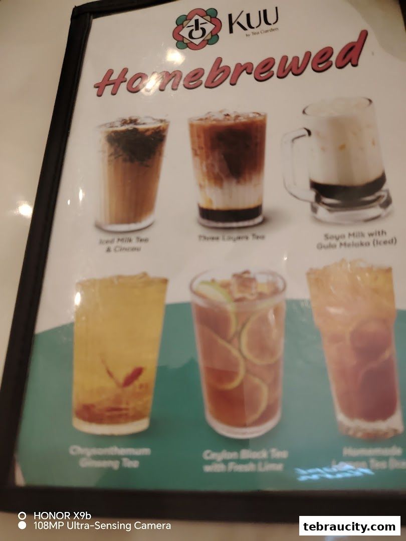 A menu board showcasing various homebrewed tea drinks with their names.