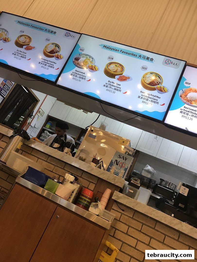 Digital menu boards displaying Malaysian food items with prices and images.
