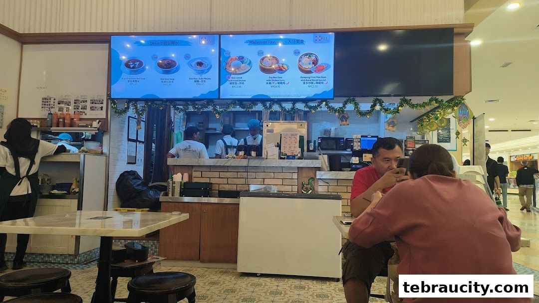 Customers seated at tables in a restaurant with digital menus displaying food items.