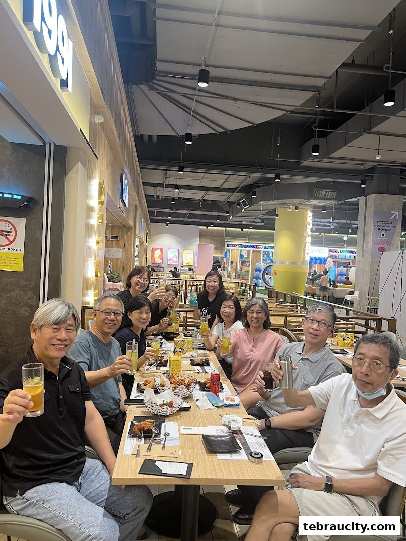 A group of people enjoying fried chicken and drinks at KyoChon1991.