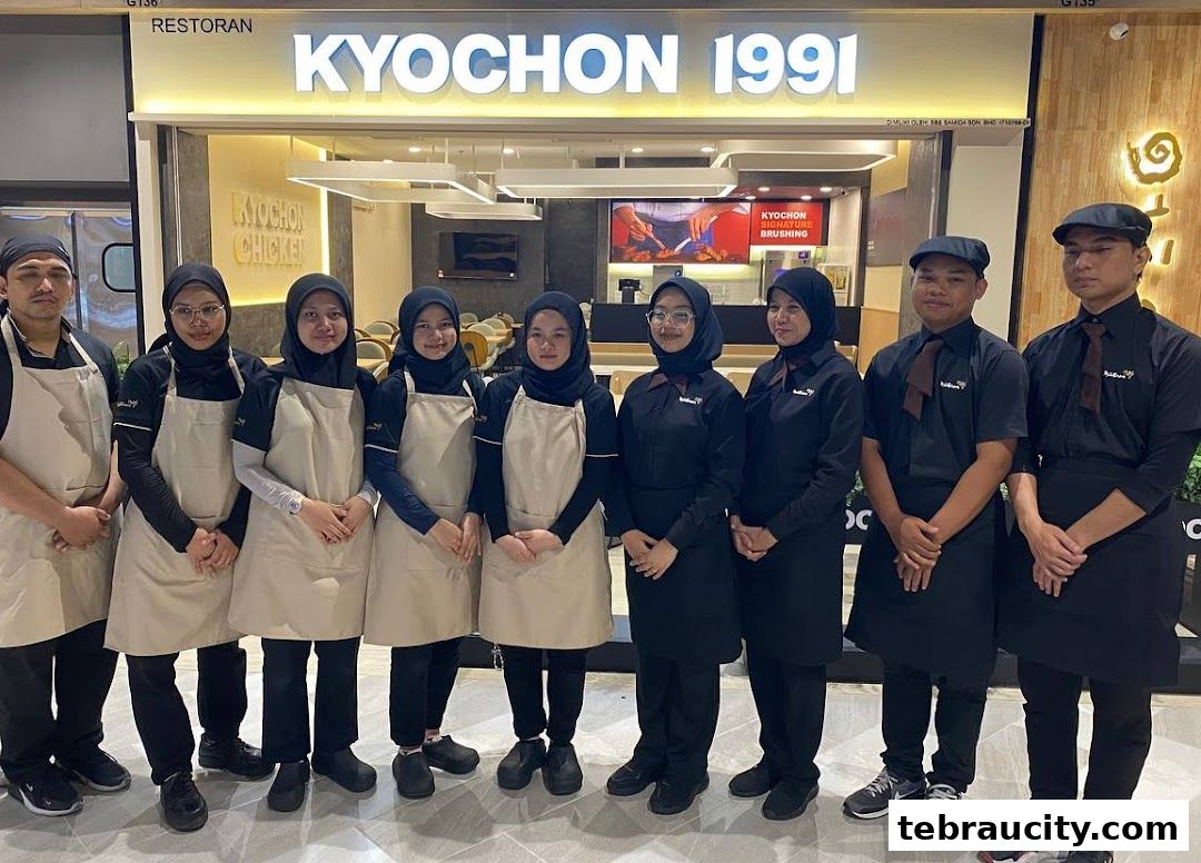 A team of staff members posing in front of the KyoChon 1991 restaurant.