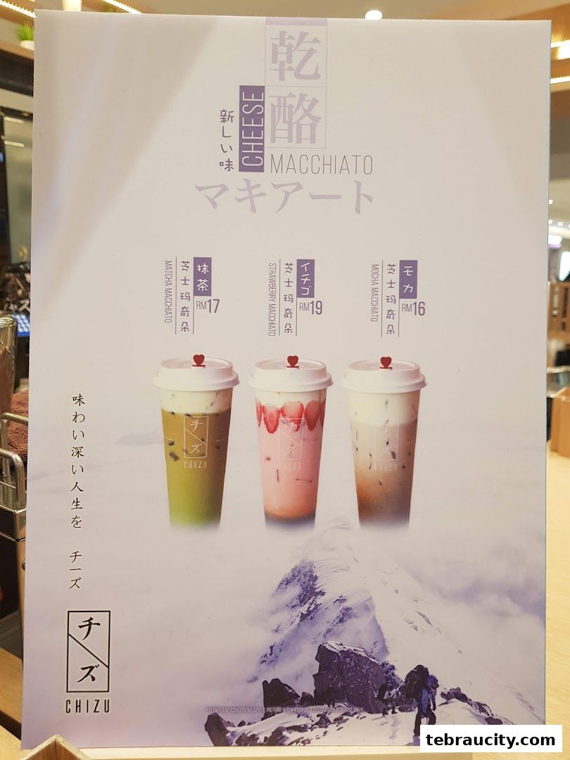 A menu board showcasing three cheese macchiato drinks: Matcha, Strawberry, and Mocha.