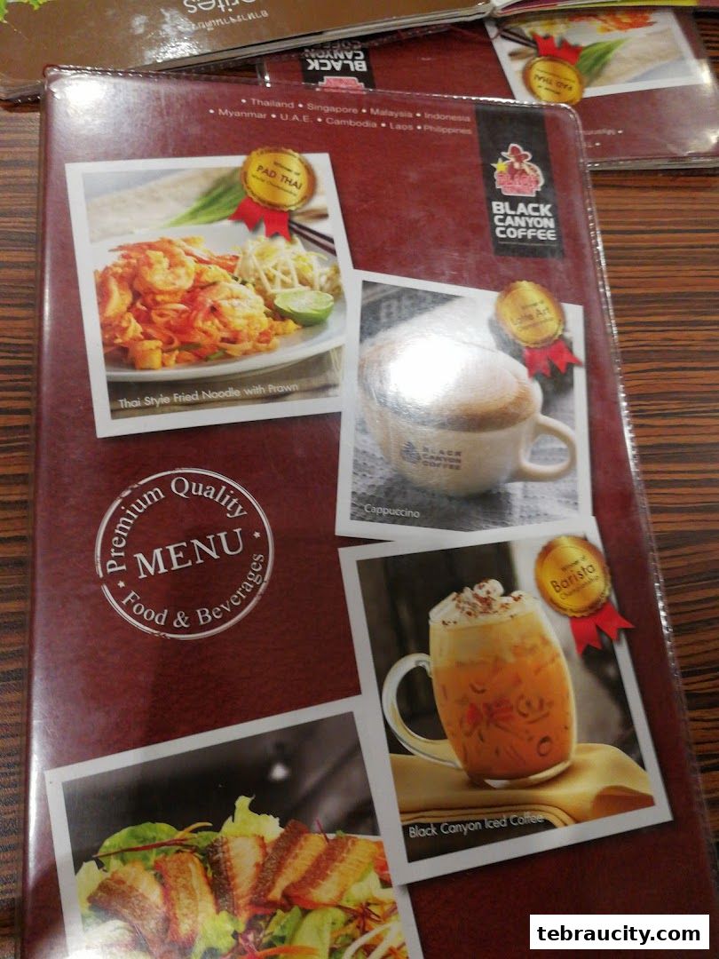 A menu from Black Canyon Coffee featuring Pad Thai, Cappuccino, and Iced Coffee.